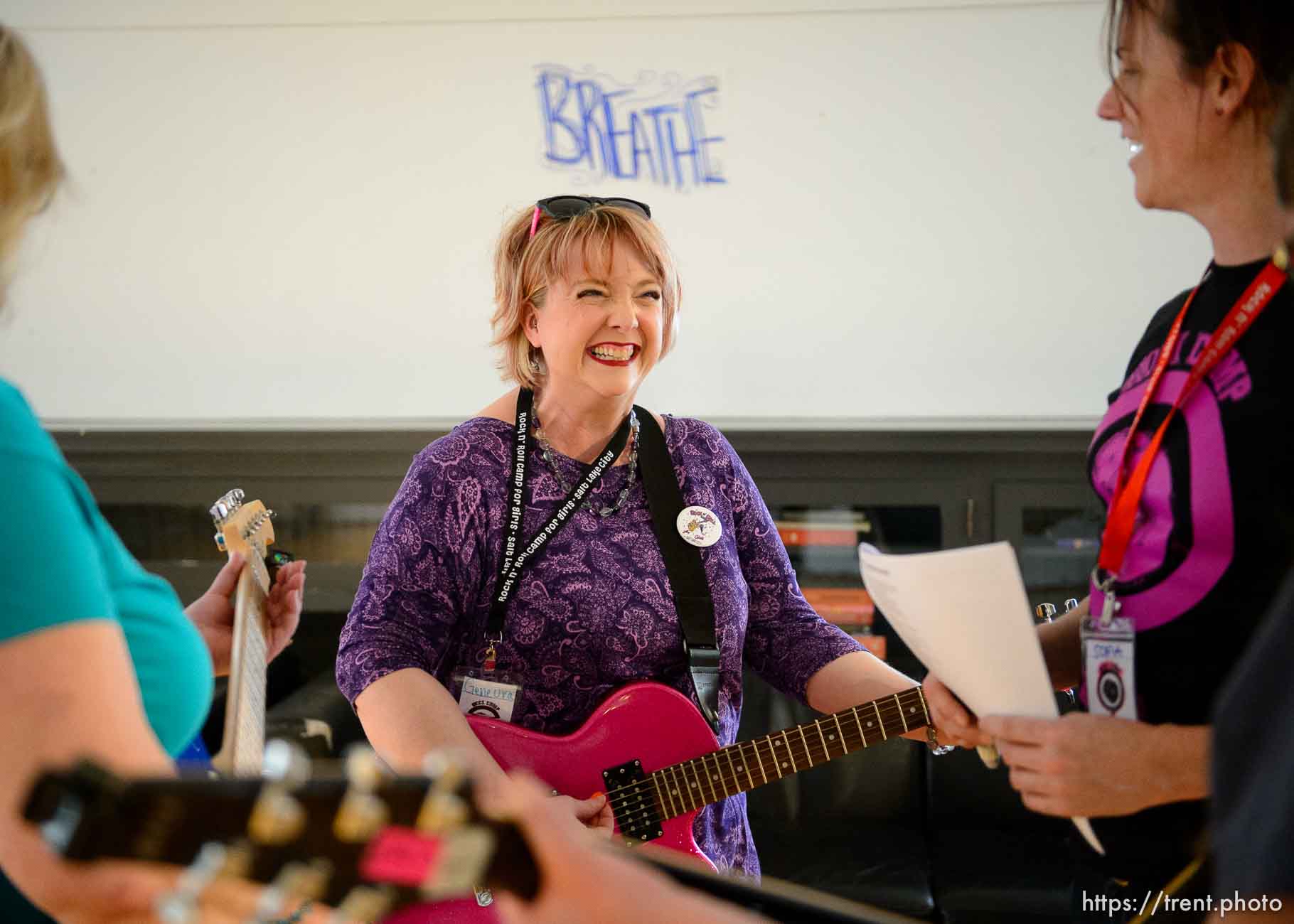 Genevra Prothero makes a discovery learning guitar from Sofia Scott at Rock Camp for Womyn. People attending the camp learn how to play instruments, form bands, write songs, and perform live in concert — all in three days. It's a new program by the same group that does Rock and Roll Camp for Girls. Salt Lake City, Friday February 2, 2018.