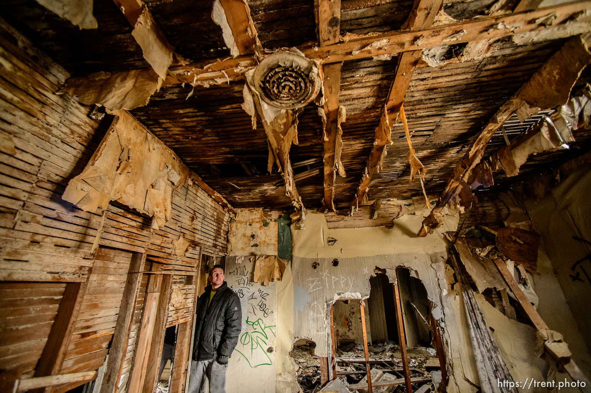 (Trent Nelson | The Salt Lake Tribune)  Jordon Holdaway in a dilapidated, fire-damaged building near 100 South 700 East in Salt Lake City, Thursday Feb. 15, 2018. Other Side Academy has received approval to demolish it for their expansion.