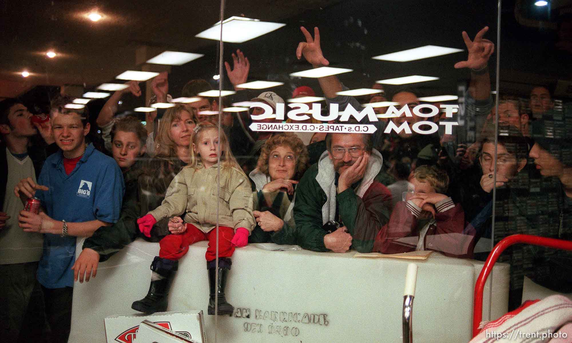 Fans who couldn't get in to the Smashing Pumpkins appearance crowded around the windows outside Tom Tom Music, a record store in Sandy. photo by Trent Nelson; 02/03/2000