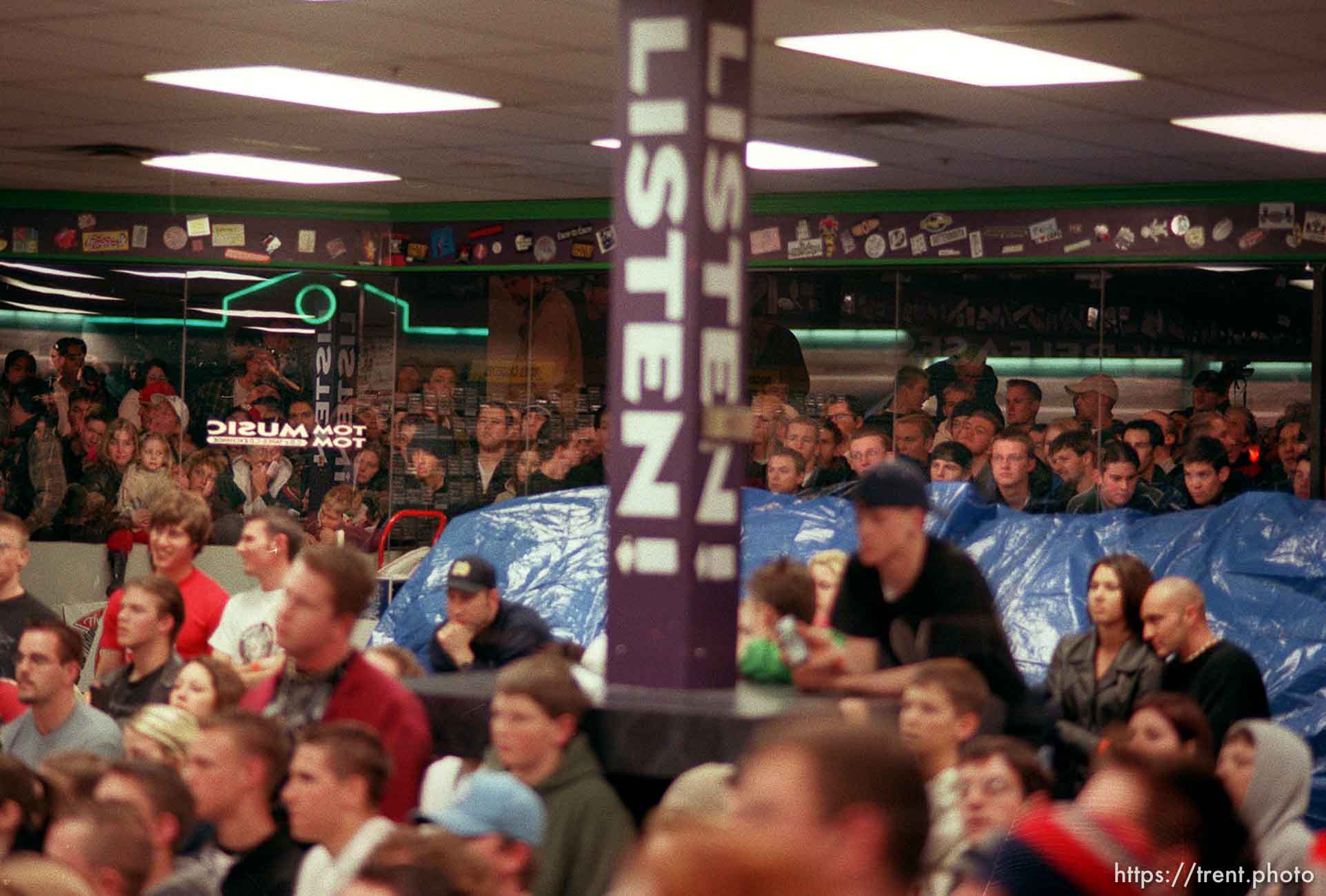 Fans who couldn't get in to the Smashing Pumpkins appearance crowded around the windows outside Tom Tom Music, a record store in Sandy. photo by Trent Nelson; 02/03/2000