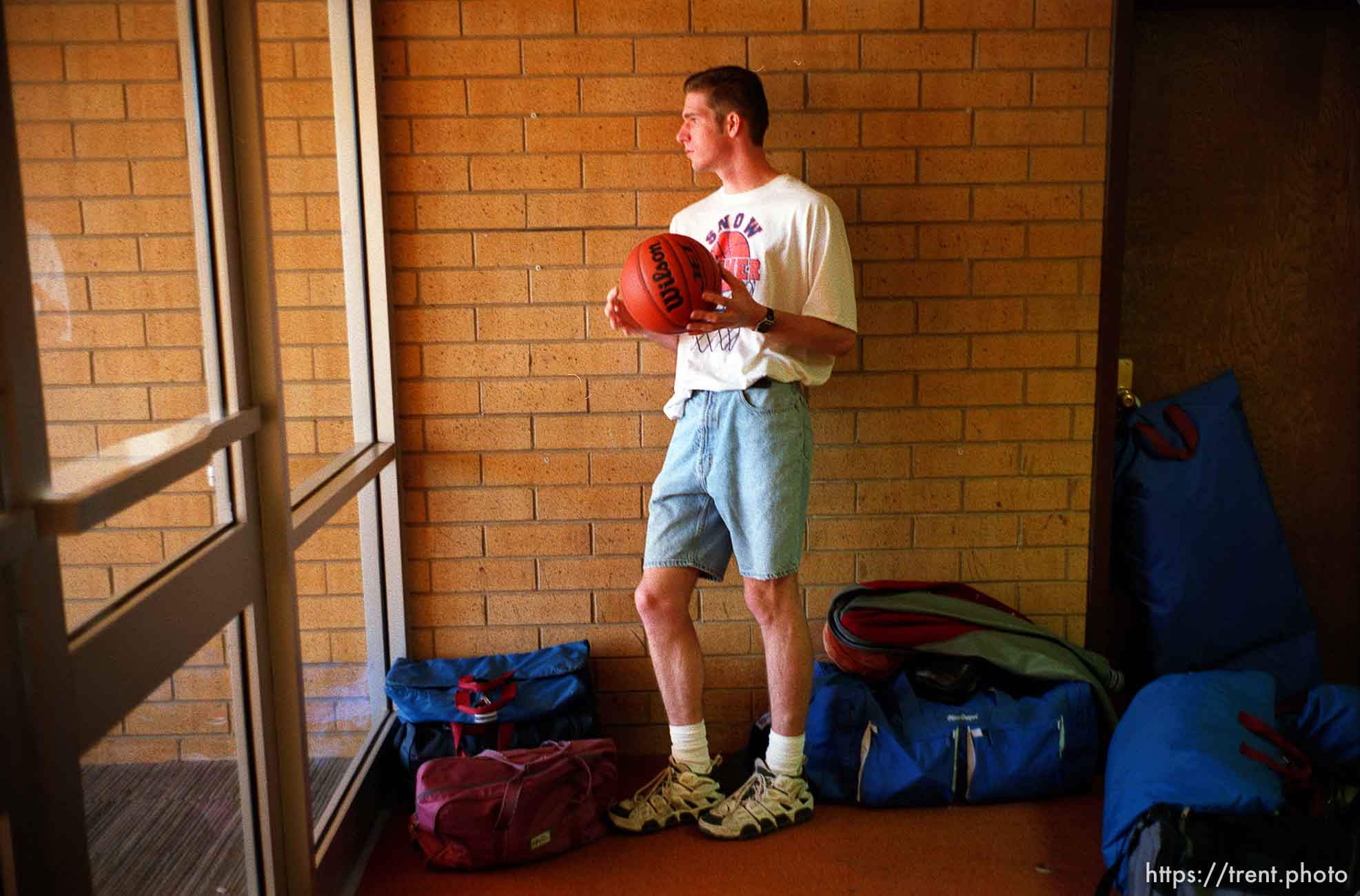 Kid holding basketball, looking out window. North Sevier Wolves state basketball championship essay.