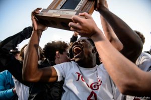 (Trent Nelson | The Salt Lake Tribune)  
Judge Memorial players celebrate their win over Morgan High School in the 3A state championship game, Saturday May 12, 2018. Holding the trophy is Ferdinand Bambabate.