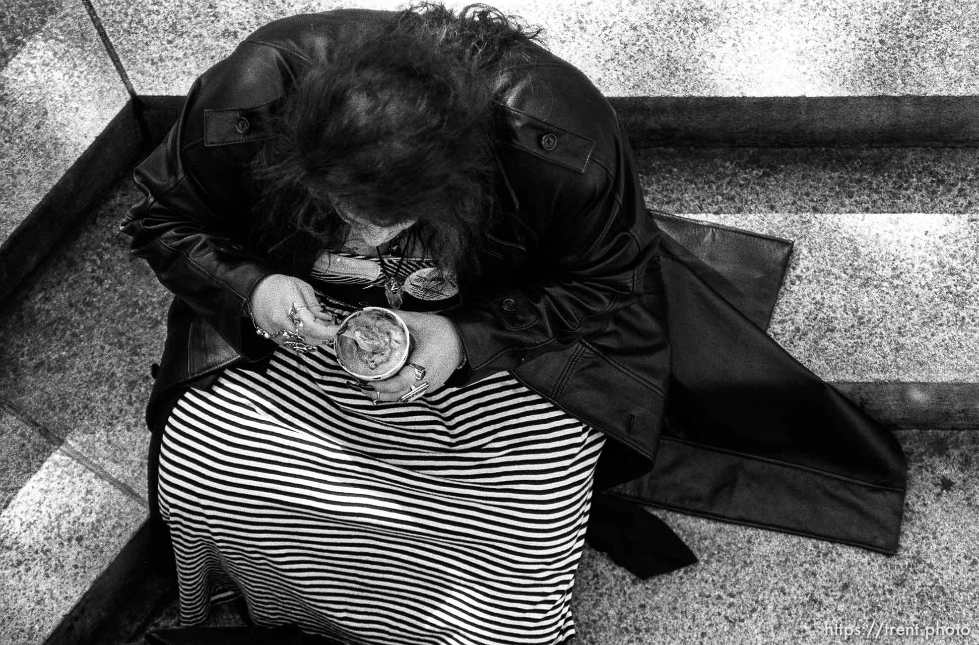 Woman eating frozen yogurt or ice cream (from above).