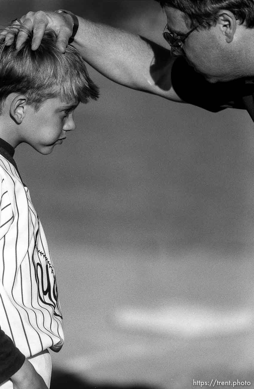 Coach talks to player at Yankees baseball game.