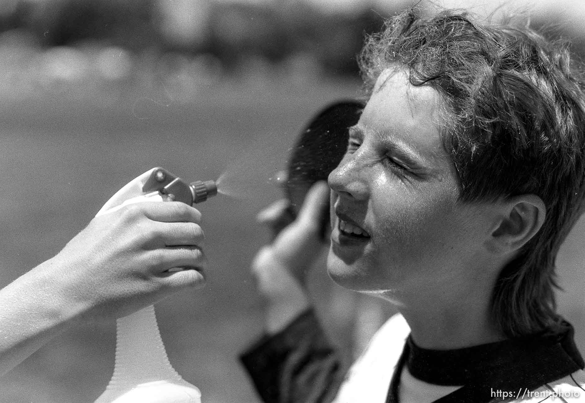 Kid has water squirted on his face at Yankee baseball game