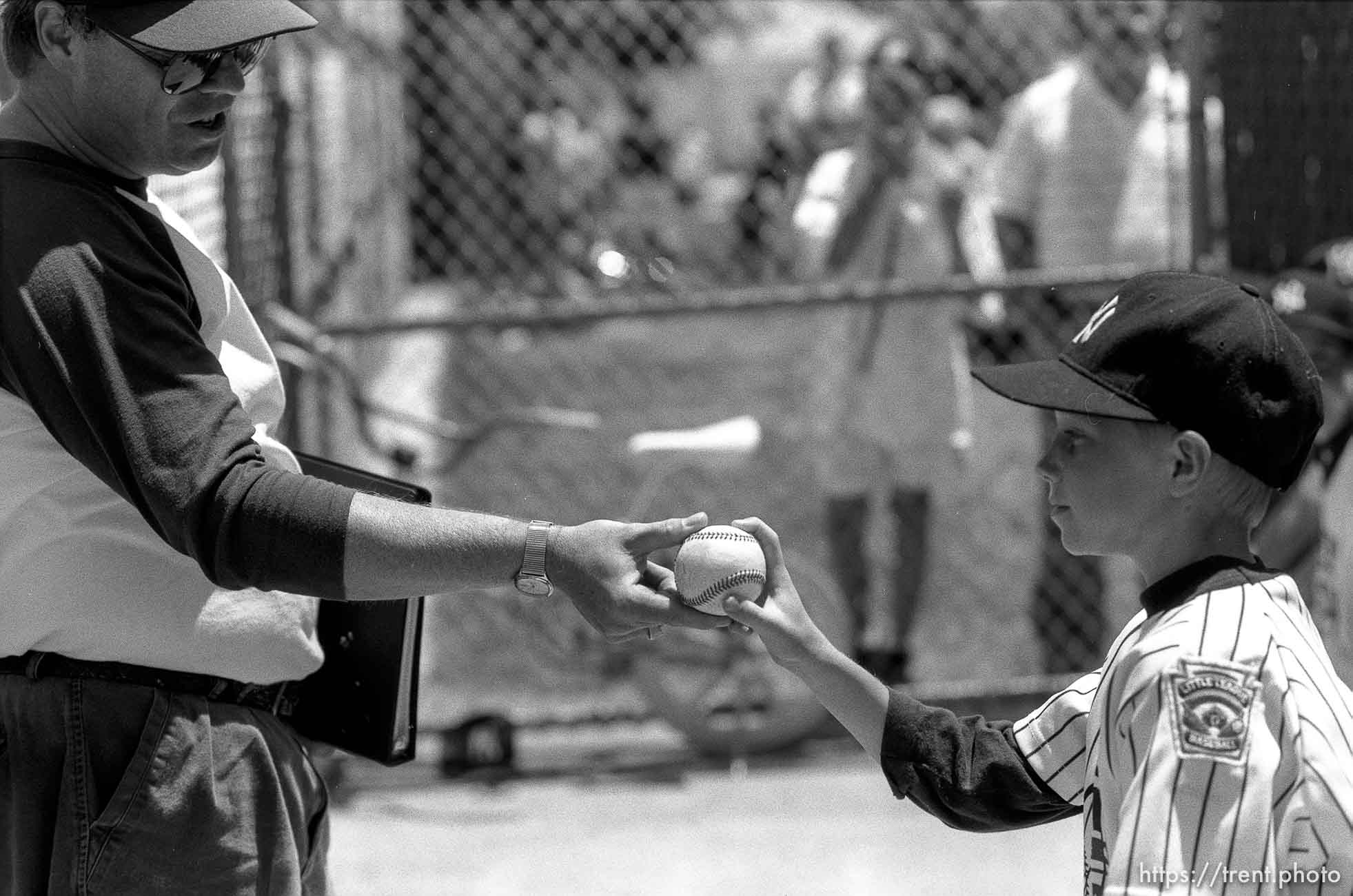 Coach gives player a game ball at Yankee baseball game