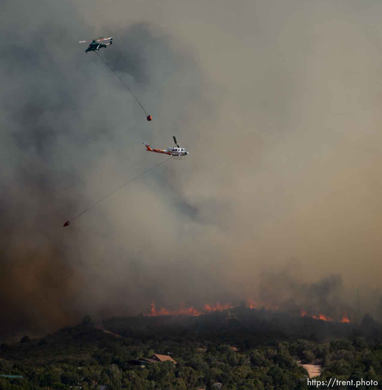 (Trent Nelson | The Salt Lake Tribune)
Helicopters make drops on the Dollar Ridge Fire near Fruitland in Duchesne County, Tuesday July 3, 2018.