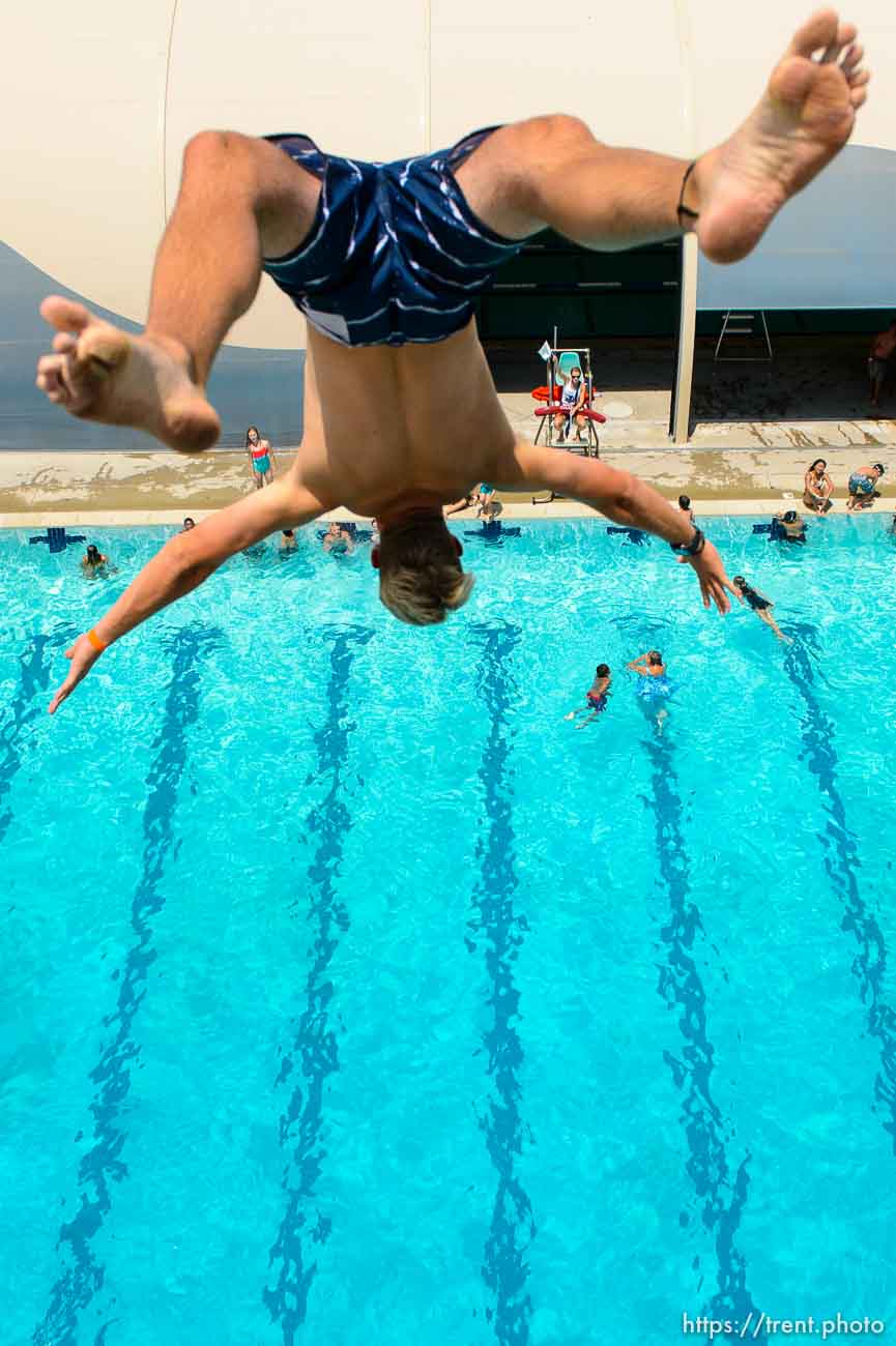 (Trent Nelson | The Salt Lake Tribune)  
A swimmer backflips from the 10 meter platform at Kearns Oquirrh Park Fitness Center, Tuesday July 10, 2018.