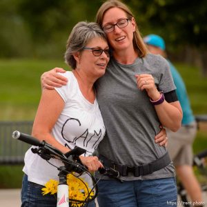 (Trent Nelson | The Salt Lake Tribune)
Cyclists gather and ride around Salt Lake City's Liberty Park, Saturday July 21, 2018, in remembrance of Cameron Hooyer, a rider who was killed by a FrontRunner train during a 999 Ride on Thursday. Hooyer's mother Carla, left, is comforted.