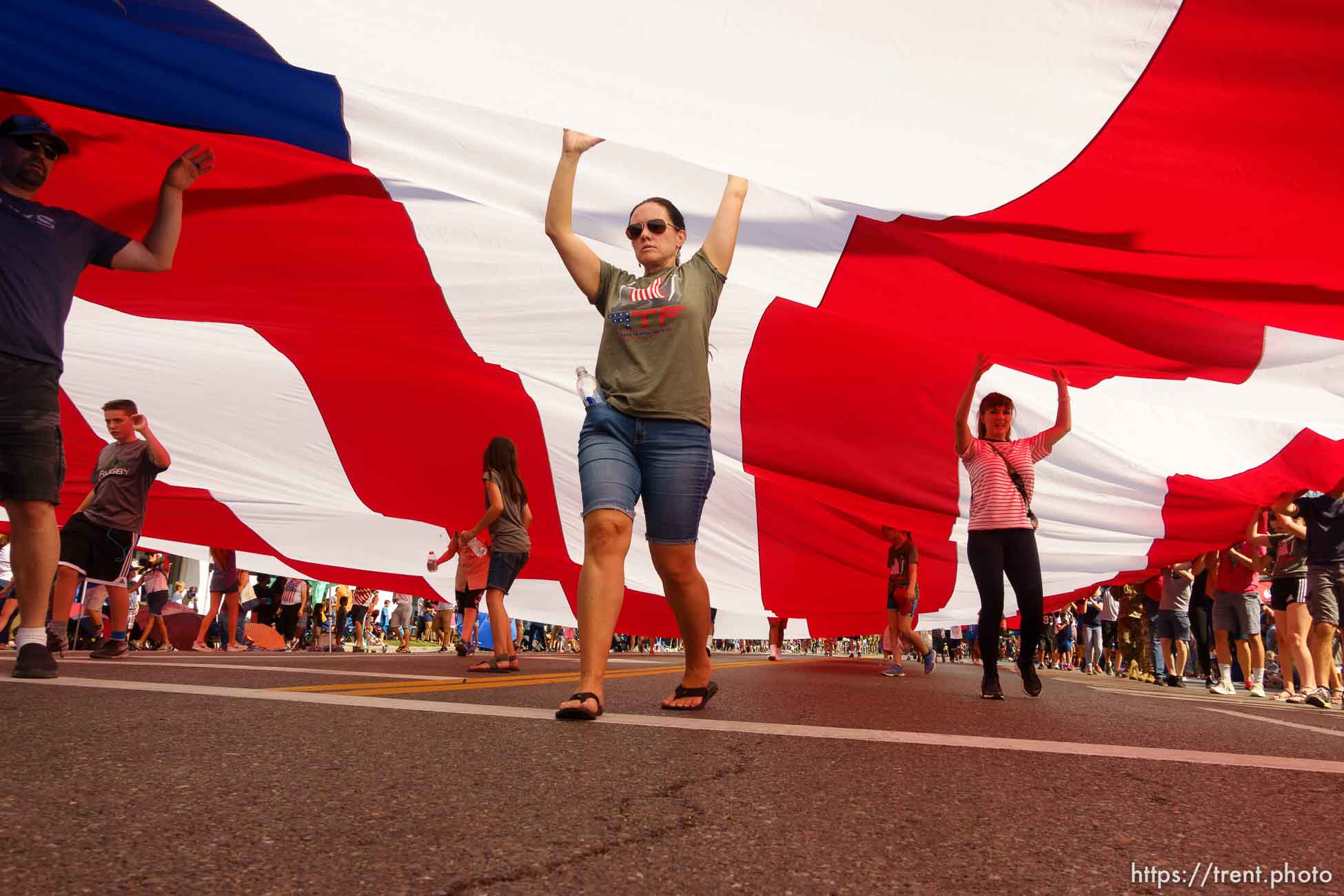 (Trent Nelson | The Salt Lake Tribune)  
The Days of '47 Parade in Salt Lake City, Tuesday July 24, 2018. Volunteers carry a large flag.