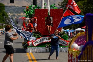 (Trent Nelson | The Salt Lake Tribune)  
The Days of '47 Parade in Salt Lake City, Tuesday July 24, 2018. Two BYU fans rush out to wave their flags in front of the University of Utah's float.