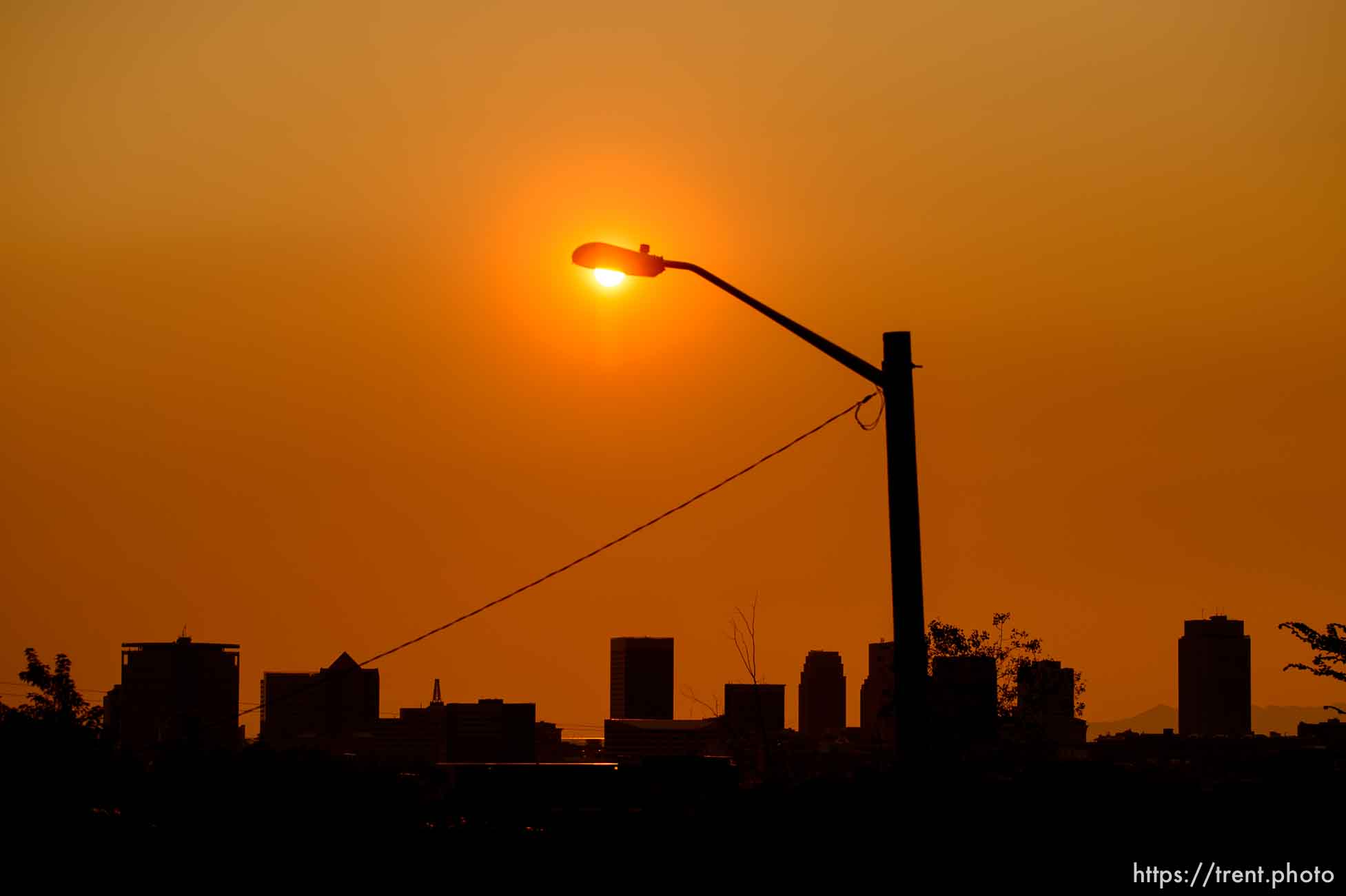 (Trent Nelson | The Salt Lake Tribune)
The sun sets over a hazy Salt Lake City, Monday Aug. 6, 2018.