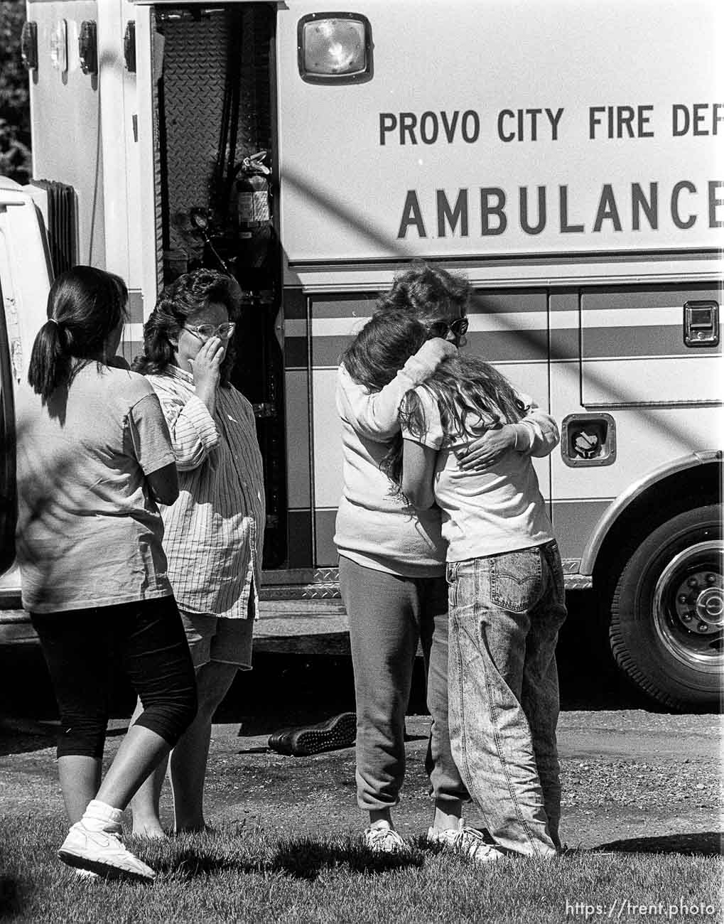 Women grieve as their home burns.