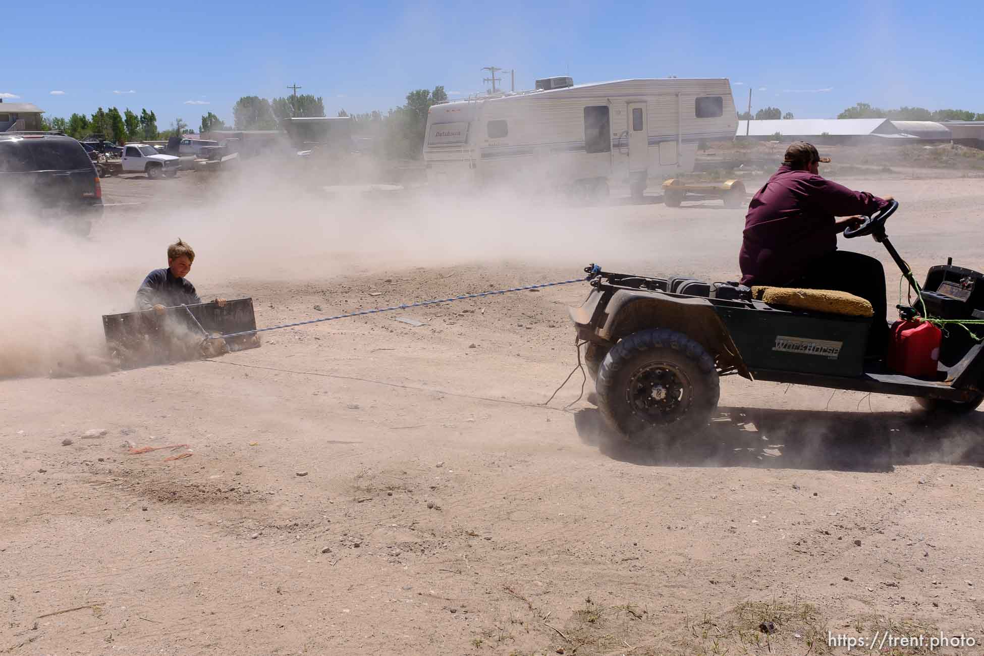 Trent Nelson  |  The Salt Lake Tribune
kids riding grate behind mover, Monday May 1, 2017.