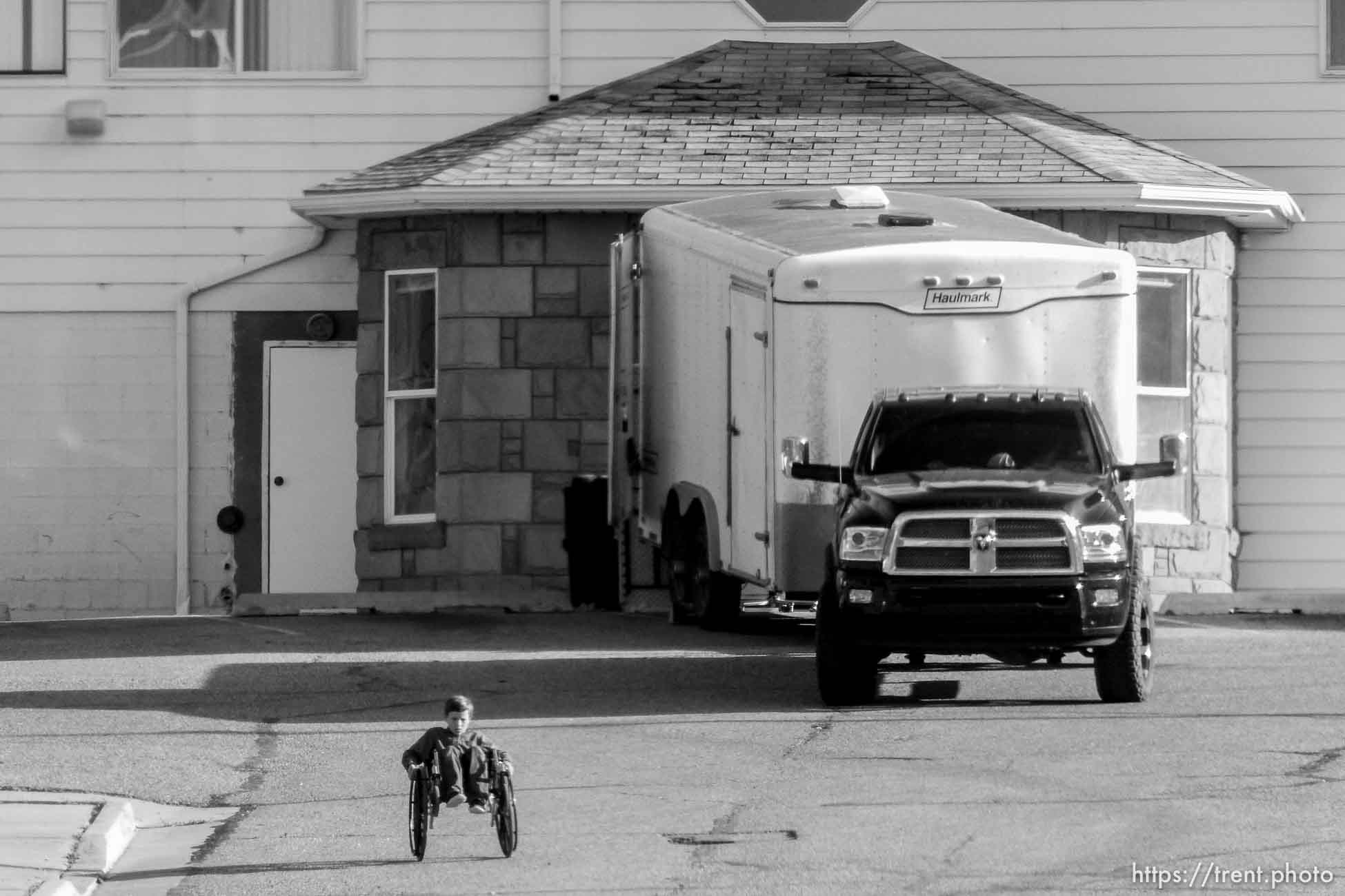 Trent Nelson  |  The Salt Lake Tribune
As the former health clinic in Hildale is emptied out in anticipation of an expected UEP Trust eviction, FLDS boys are seen rolling wheelchairs down the long driveway, Monday May 8, 2017.