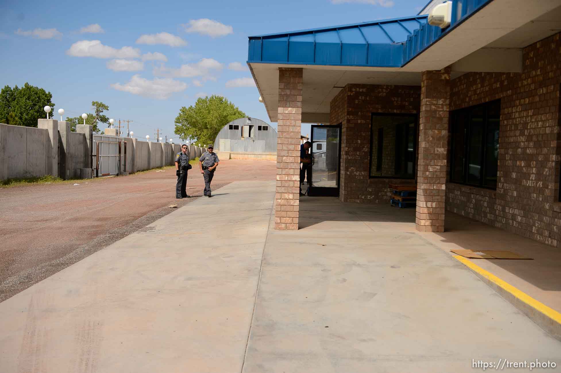 Trent Nelson  |  The Salt Lake Tribune
Mohave County Sheriff deputies on the grounds of what had been the FLDS food storehouse in Colorado City, AZ, as locksmith Kelvin Holdaway changes the locks during an eviction, Monday May 8, 2017.