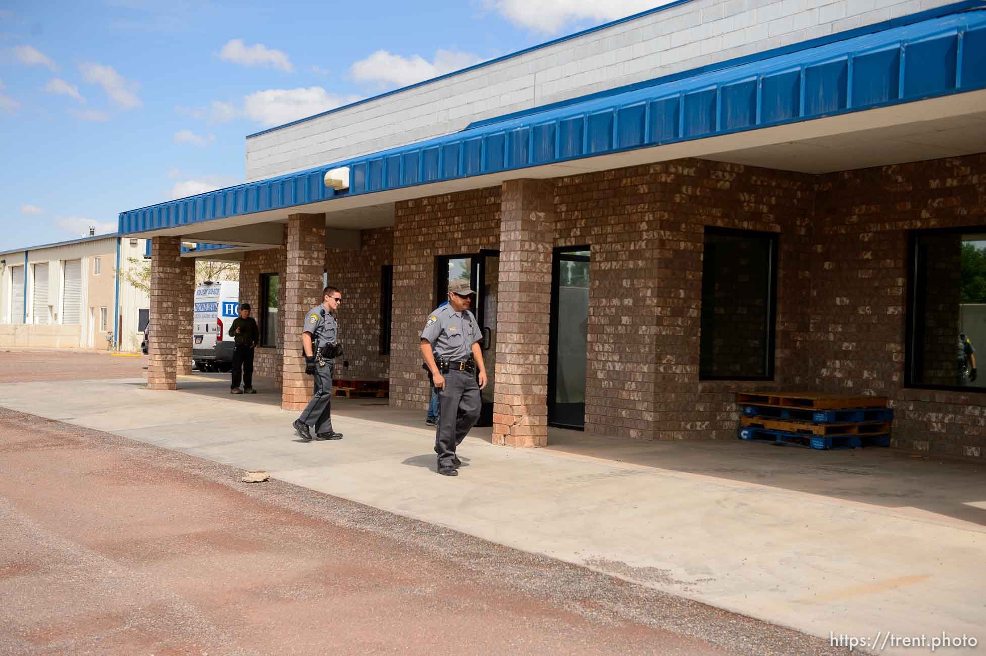 Trent Nelson  |  The Salt Lake Tribune
Mohave County Sheriff deputies on the grounds of what had been the FLDS food storehouse in Colorado City, AZ, as locksmith Kelvin Holdaway changes the locks during an eviction, Monday May 8, 2017.