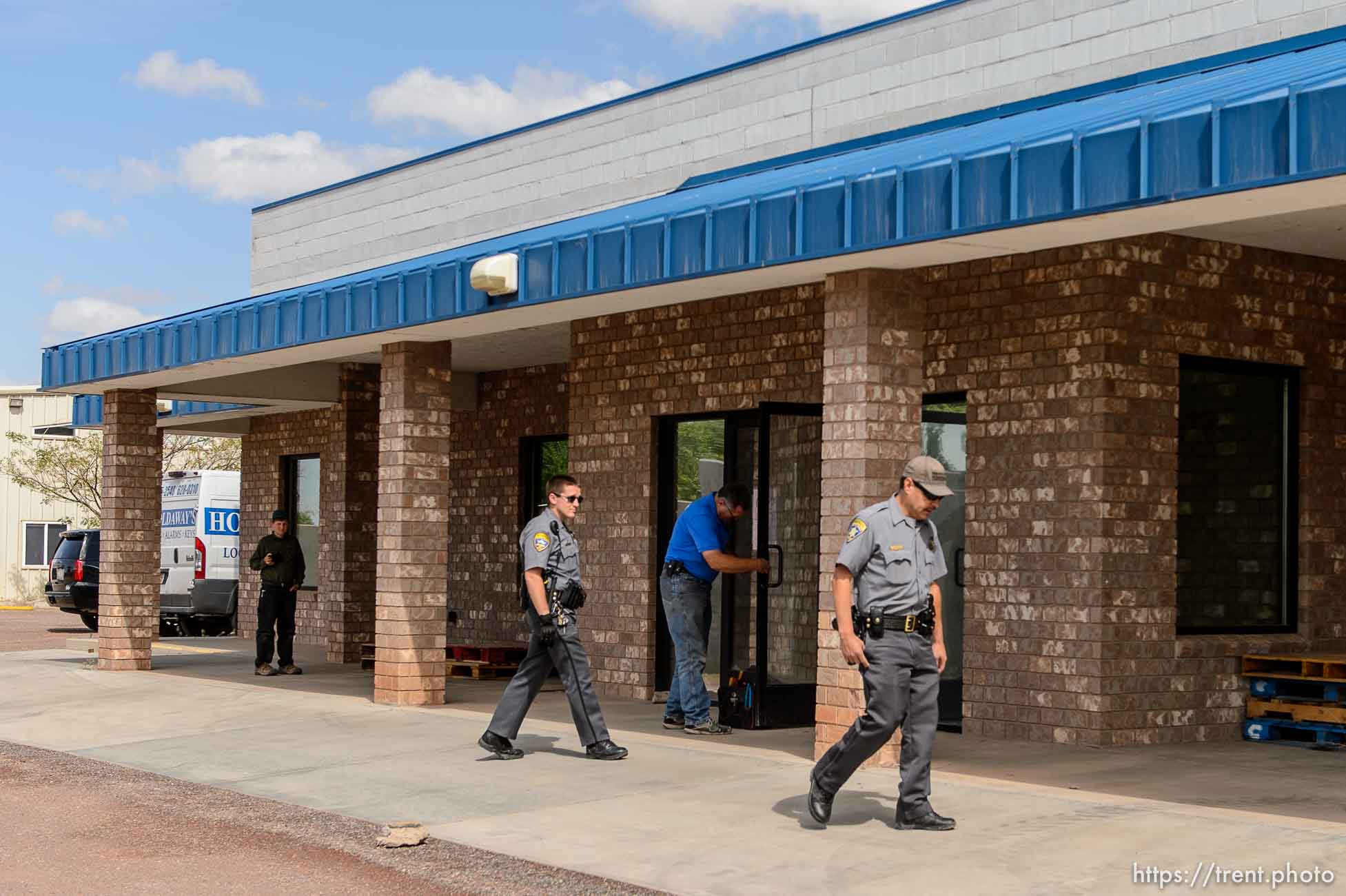 Trent Nelson  |  The Salt Lake Tribune
Mohave County Sheriff deputies on the grounds of what had been the FLDS food storehouse in Colorado City, AZ, as locksmith Kelvin Holdaway changes the locks during an eviction, Monday May 8, 2017.