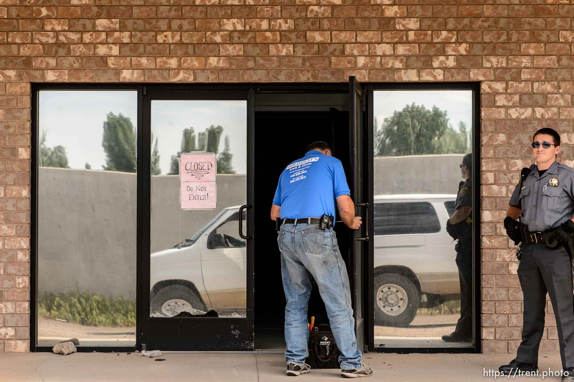 Trent Nelson  |  The Salt Lake Tribune
Mohave County Sheriff deputies on the grounds of what had been the FLDS food storehouse in Colorado City, AZ, as locksmith Kelvin Holdaway changes the locks during an eviction, Monday May 8, 2017.