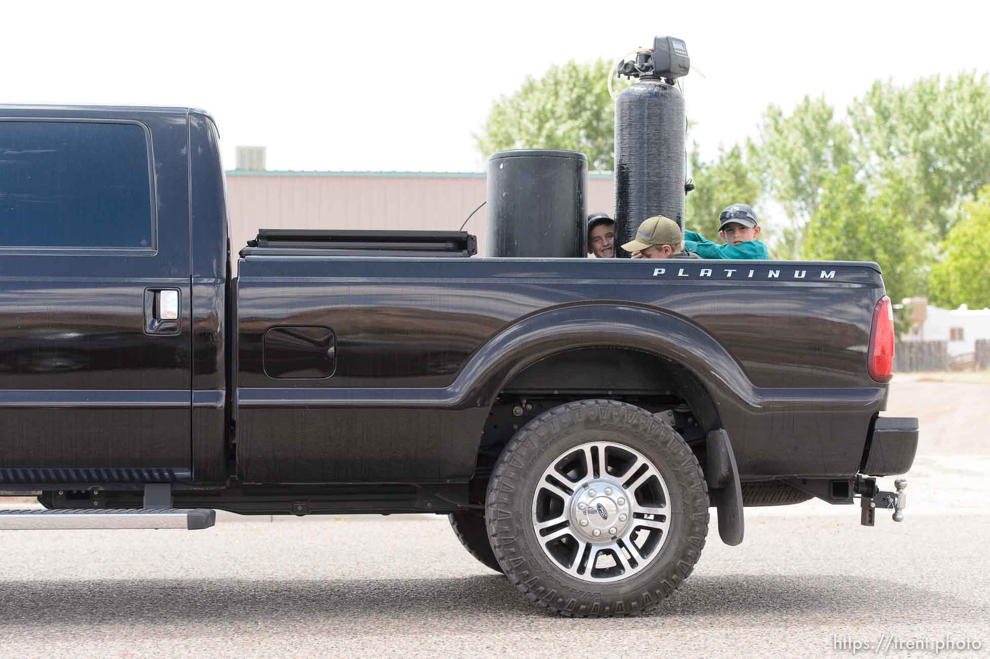 Trent Nelson  |  The Salt Lake Tribune
flds boys moving equipment from south yard, former FLDS storehouse, as UEP Trust eviction takes place, Monday May 8, 2017.