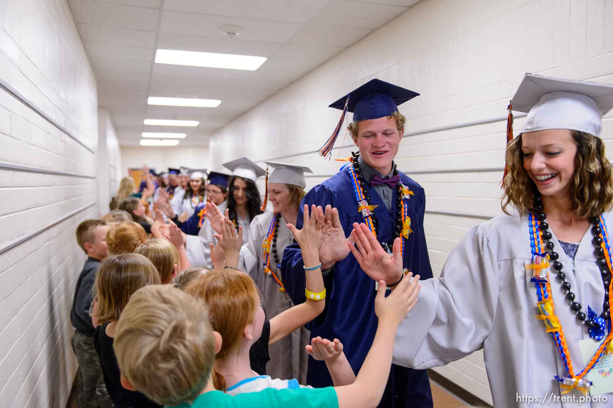 Trent Nelson  |  The Salt Lake Tribune
Water Canyon High School graduates walk a procession of high-fives through Water Canyon Elementary prior to the high school's graduation ceremony in Hildale, Monday May 22, 2017. Two years ago the school had one graduate, this year twenty-five.