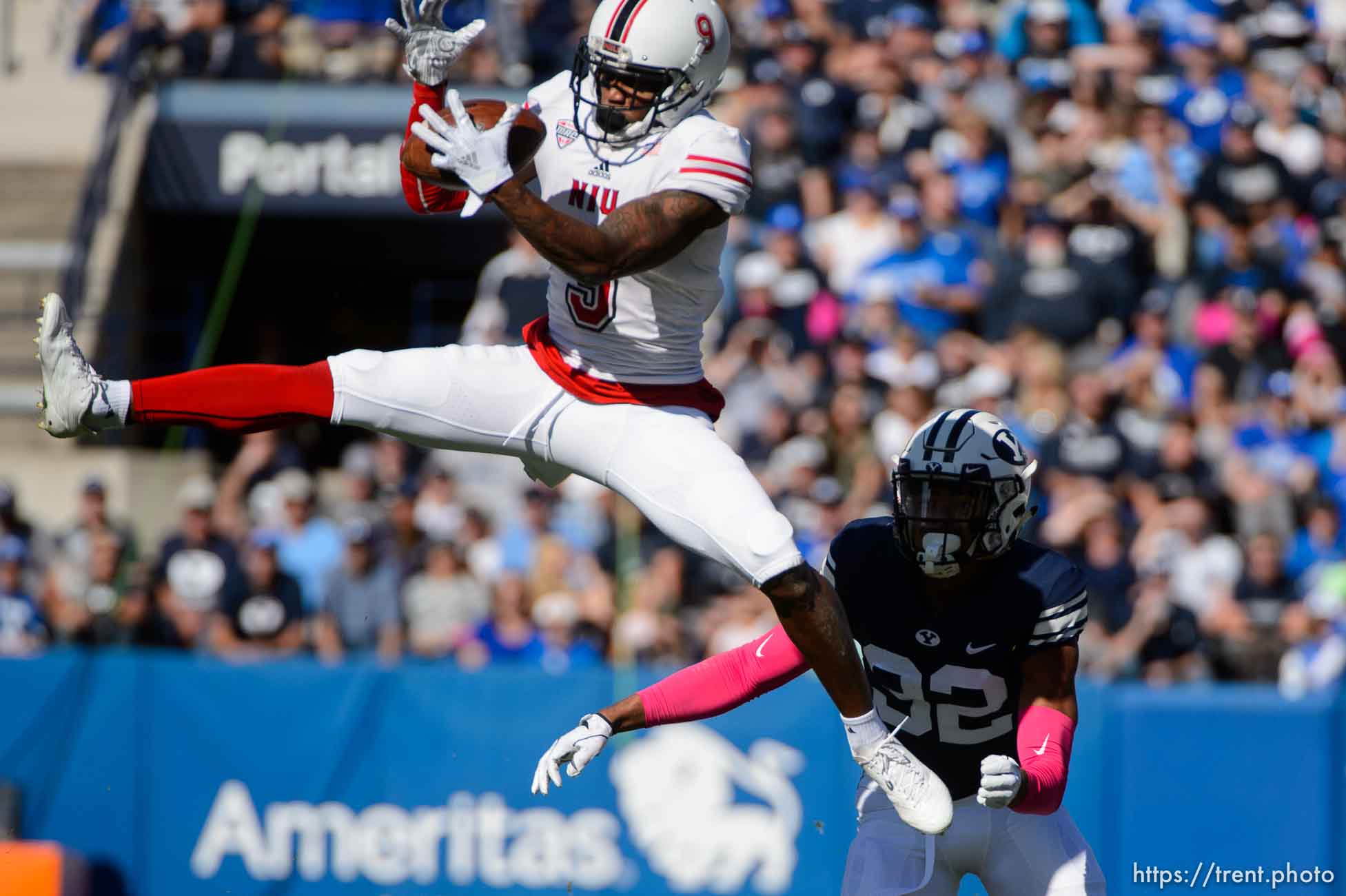 (Trent Nelson | The Salt Lake Tribune)  
Northern Illinois Huskies wide receiver Jauan Wesley (9) leaps for a reception ahead of Brigham Young Cougars defensive back Chris Wilcox (32) as BYU hosts Northern Illinois, NCAA football in Provo, Saturday Oct. 27, 2018.