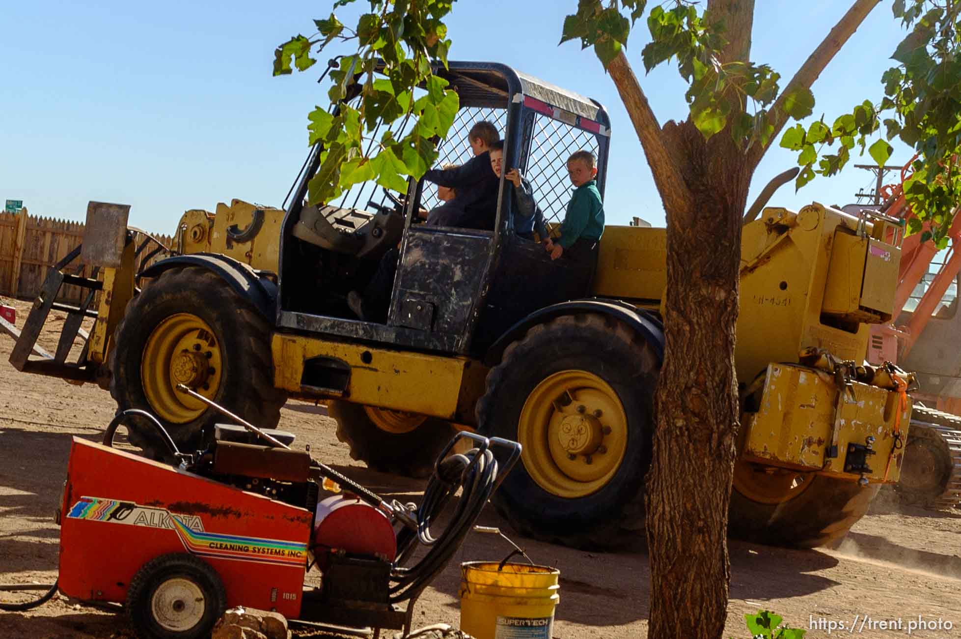 Trent Nelson  |  The Salt Lake Tribune
pre-pubescent boys on heavy equipment at property being sold by hildale city, Wednesday September 14, 2016.