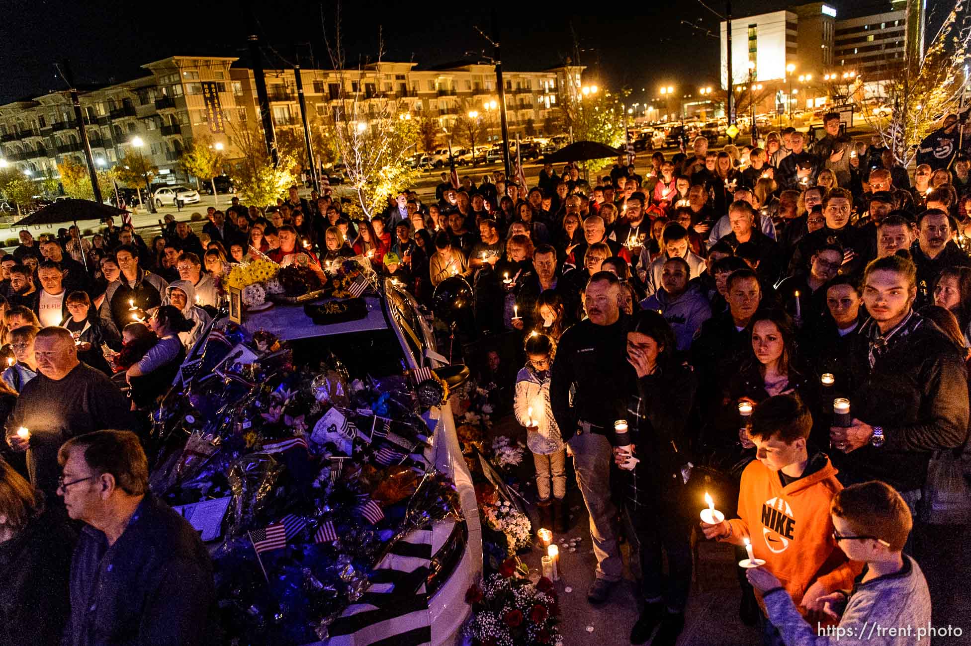 Trent Nelson  |  The Salt Lake Tribune
A crowd gathers around the patrol vehicle of West Valley City police officer Cody Brotherson, who was killed Sunday while apparently trying to lay down tire spikes to stop a fleeing stolen car, during a candlelight vigil in his honor Wednesday November 9, 2016.