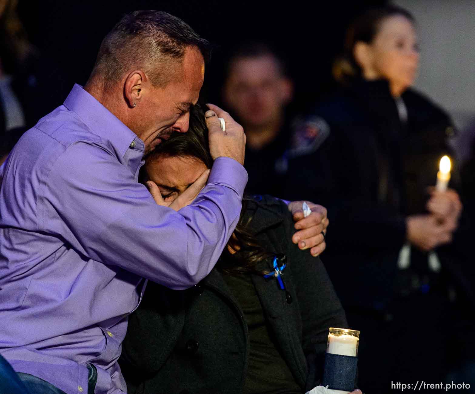 Trent Nelson  |  The Salt Lake Tribune
Jeff Brotherson, father of fallen West Valley City police officer Cody Brotherson, embraces his son's fiance Jessica Le at a candlelight vigil in West Valley City Wednesday November 9, 2016. Brotherson was killed Sunday while apparently trying to lay down tire spikes to stop a fleeing stolen car.