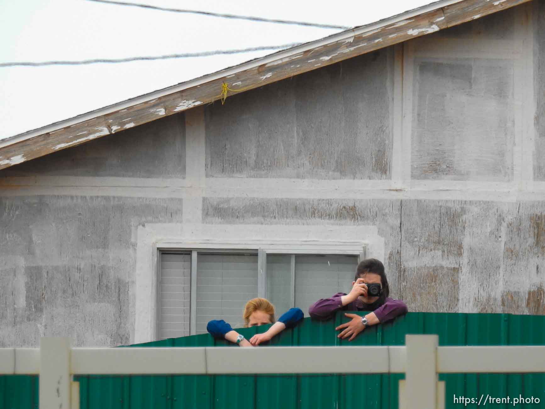 Trent Nelson  |  The Salt Lake Tribune
An FLDS girl photographs as the locks are changed during an eviction on an empty home in Colorado City, AZ, Tuesday May 9, 2017.