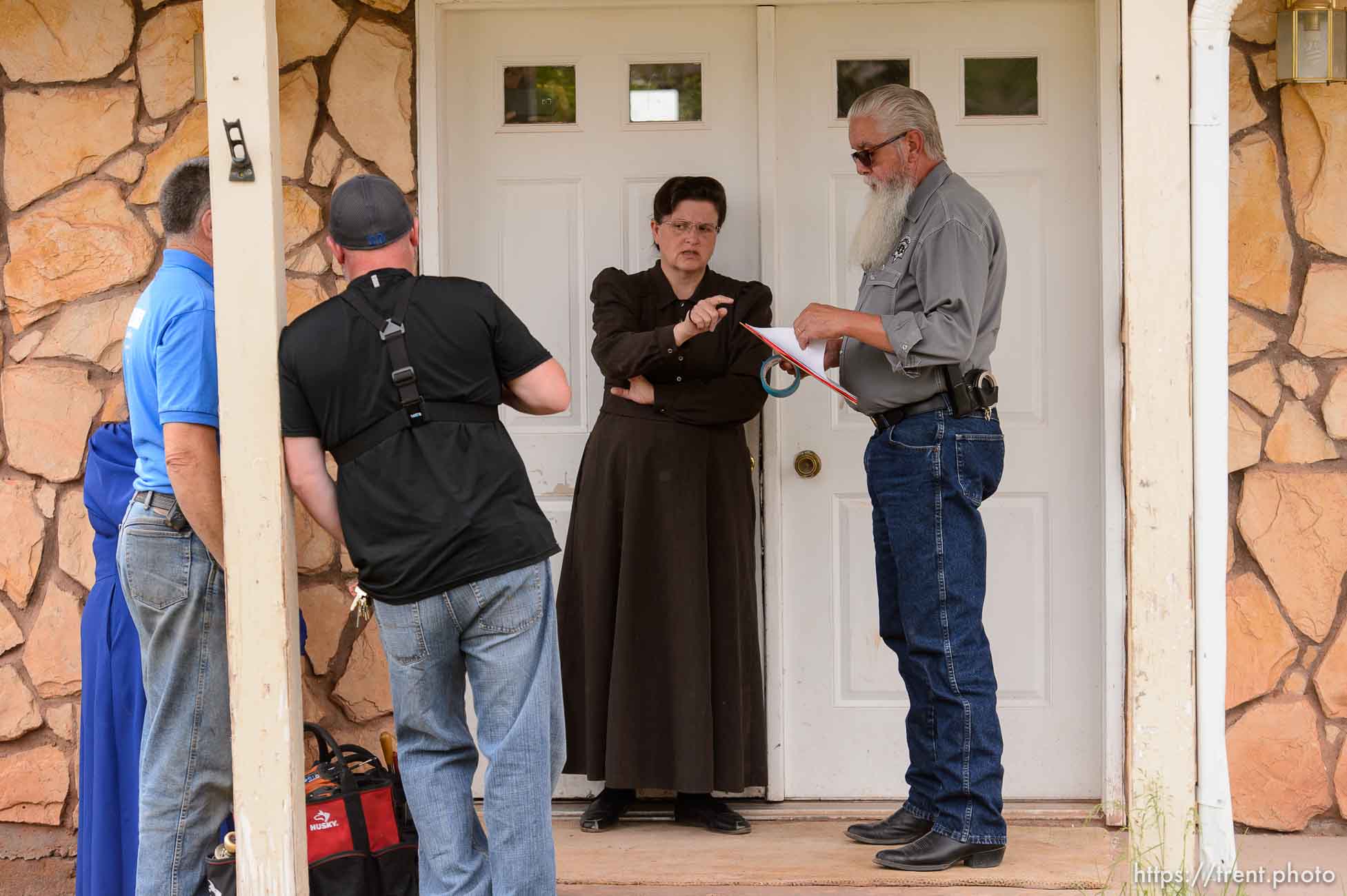 Trent Nelson  |  The Salt Lake Tribune
An FLDS woman confronts UEP agent Ted Barlow and Mohave County Constable Mike Hoggard as they evict her from her home in Colorado City, AZ, facing eviction, Tuesday May 9, 2017. Locksmith Kelvin Holdaway in blue shirt.
