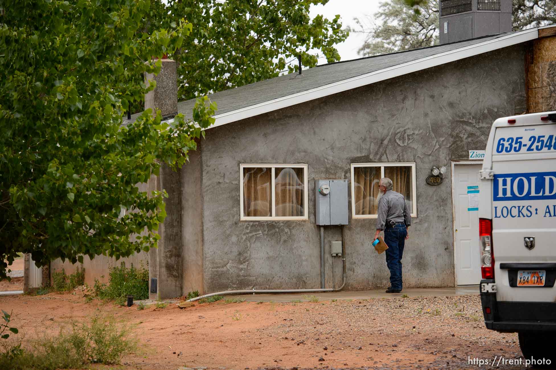 Trent Nelson  |  The Salt Lake Tribune
Two FLDS women are evicted from a home in Colorado City, AZ, Tuesday May 9, 2017, and walk off in the rain. Mohave County Constable Mike Hoggard.