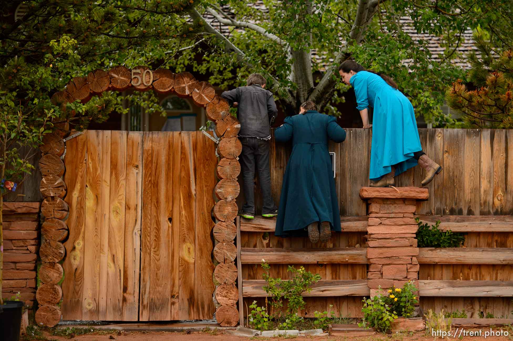 Trent Nelson  |  The Salt Lake Tribune
FLDS children look over a wall as the UEP Trust has the locks changed on an FLDS home in Colorado City, AZ, Wednesday May 10, 2017.