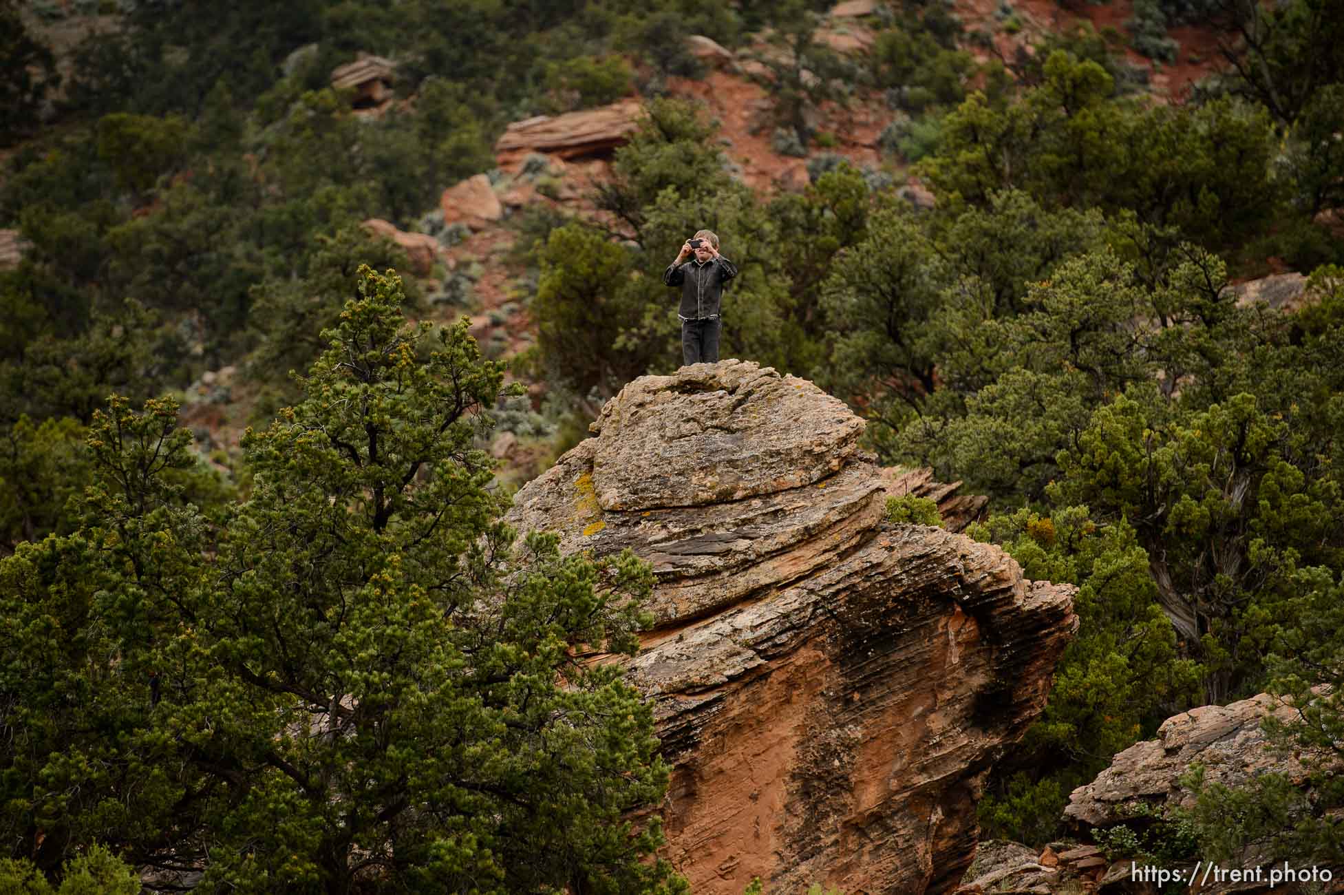 Trent Nelson  |  The Salt Lake Tribune
FLDS boy photographs from the top of a rock as the UEP changes the locks on the home at 560 E Johnson Ave, Colorado City, AZ, Wednesday May 10, 2017.