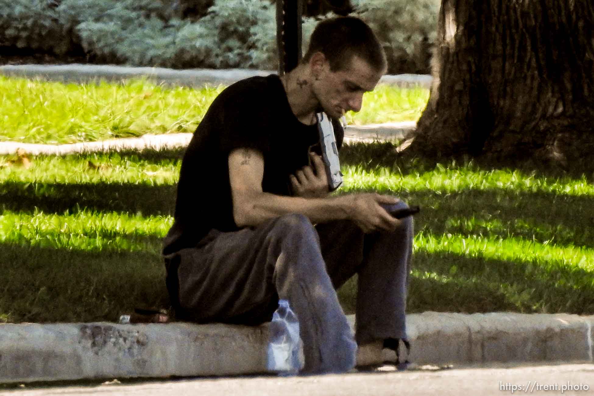 (Trent Nelson | The Salt Lake Tribune)  A young man holds a gun to his head during a standoff with police in Salt Lake City, Friday September 1, 2017.