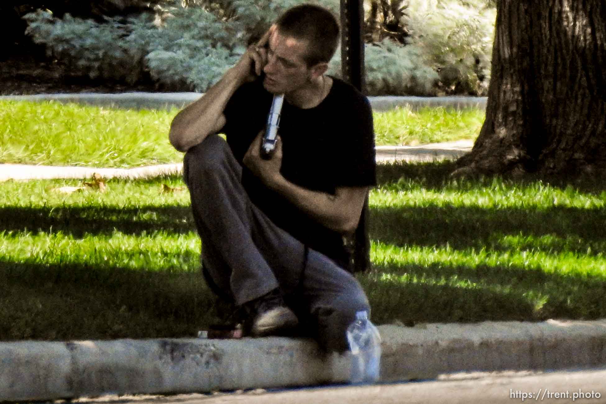 (Trent Nelson | The Salt Lake Tribune)  A young man holds a gun to his head during a standoff with police in Salt Lake City, Friday September 1, 2017.