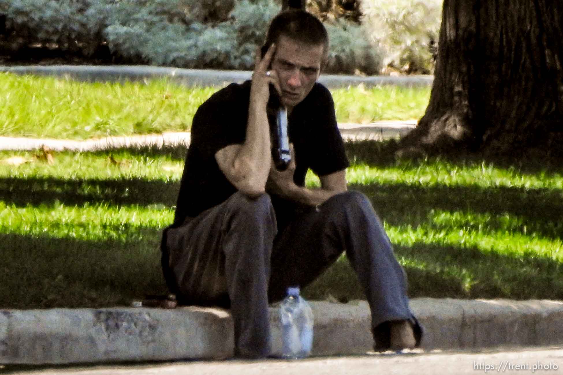 (Trent Nelson | The Salt Lake Tribune)  A young man holds a gun to his head during a standoff with police in Salt Lake City, Friday September 1, 2017.