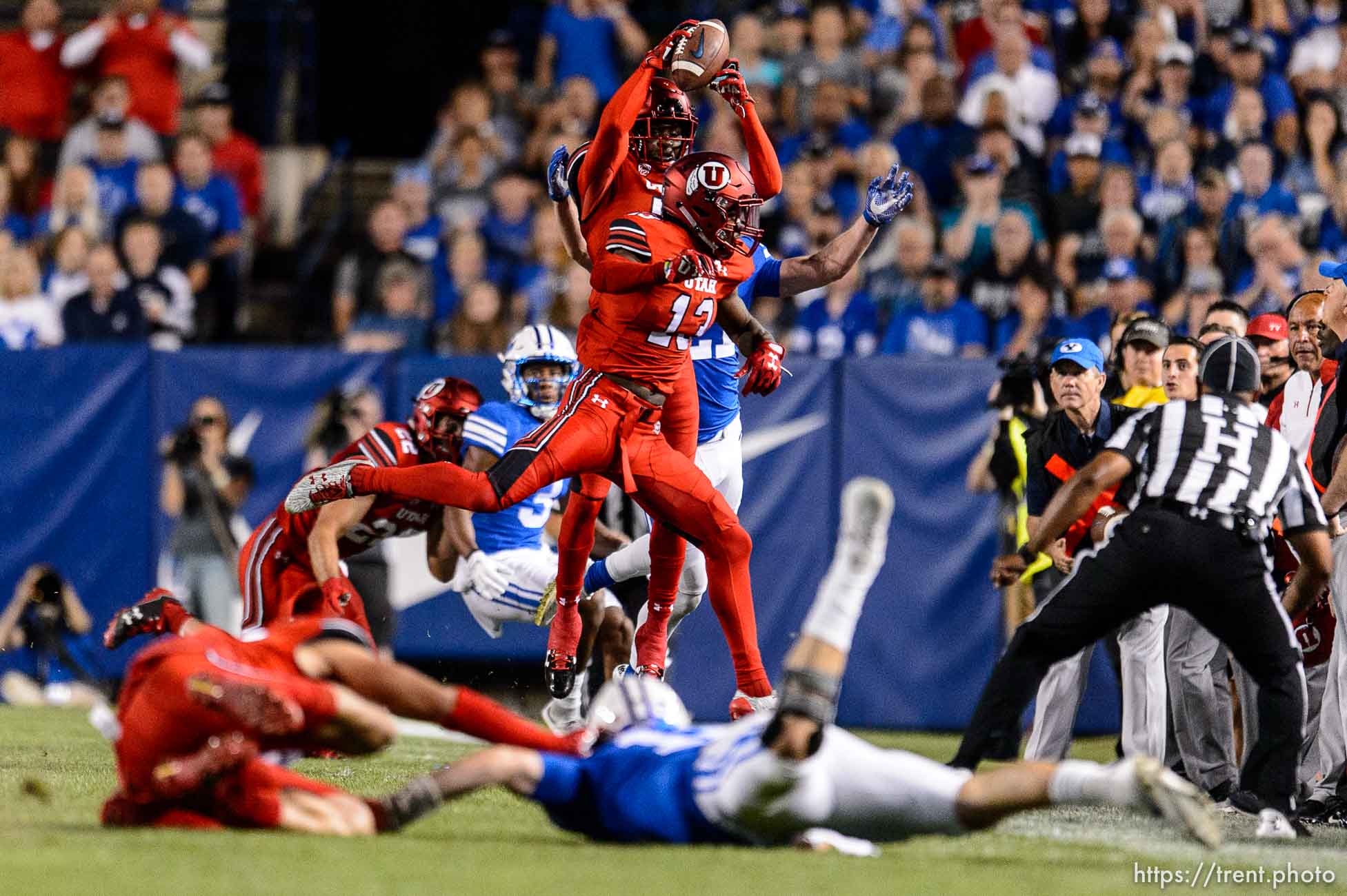 (Trent Nelson | The Salt Lake Tribune)  Utah Utes defensive back Jaylon Johnson (7) pulls in an interception as Brigham Young Cougars quarterback Tanner Mangum (12) is brought down by Utah Utes defensive end Caleb Repp (47), but is ruled out of bounds as BYU hosts Utah, NCAA football in Provo, Saturday September 9, 2017.