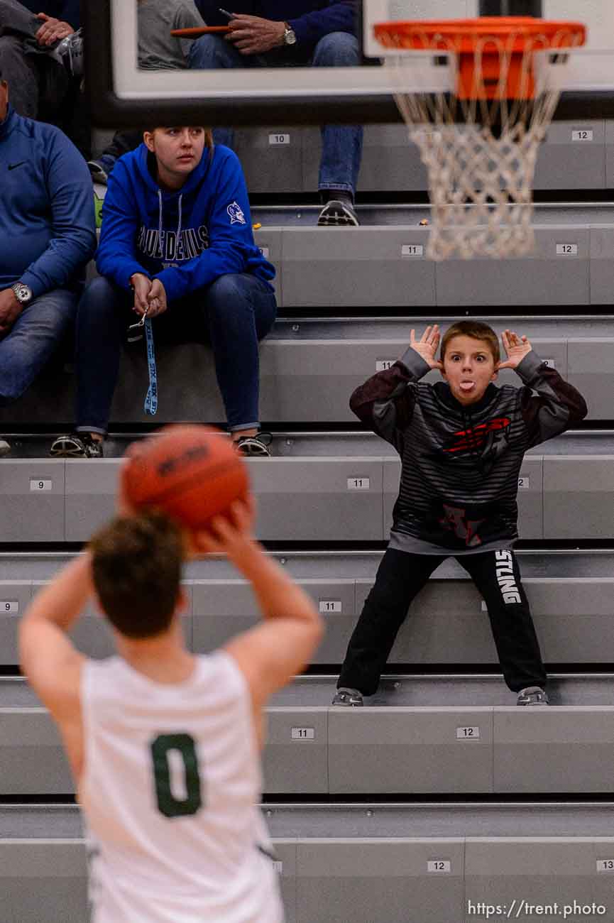 (Trent Nelson | The Salt Lake Tribune)  A young American Fork fan works on distracting Olympus's Jeremy DowDell at the free throw line as American Fork hosts Olympus in the Utah Elite Eight tournament, Saturday December 9, 2017.