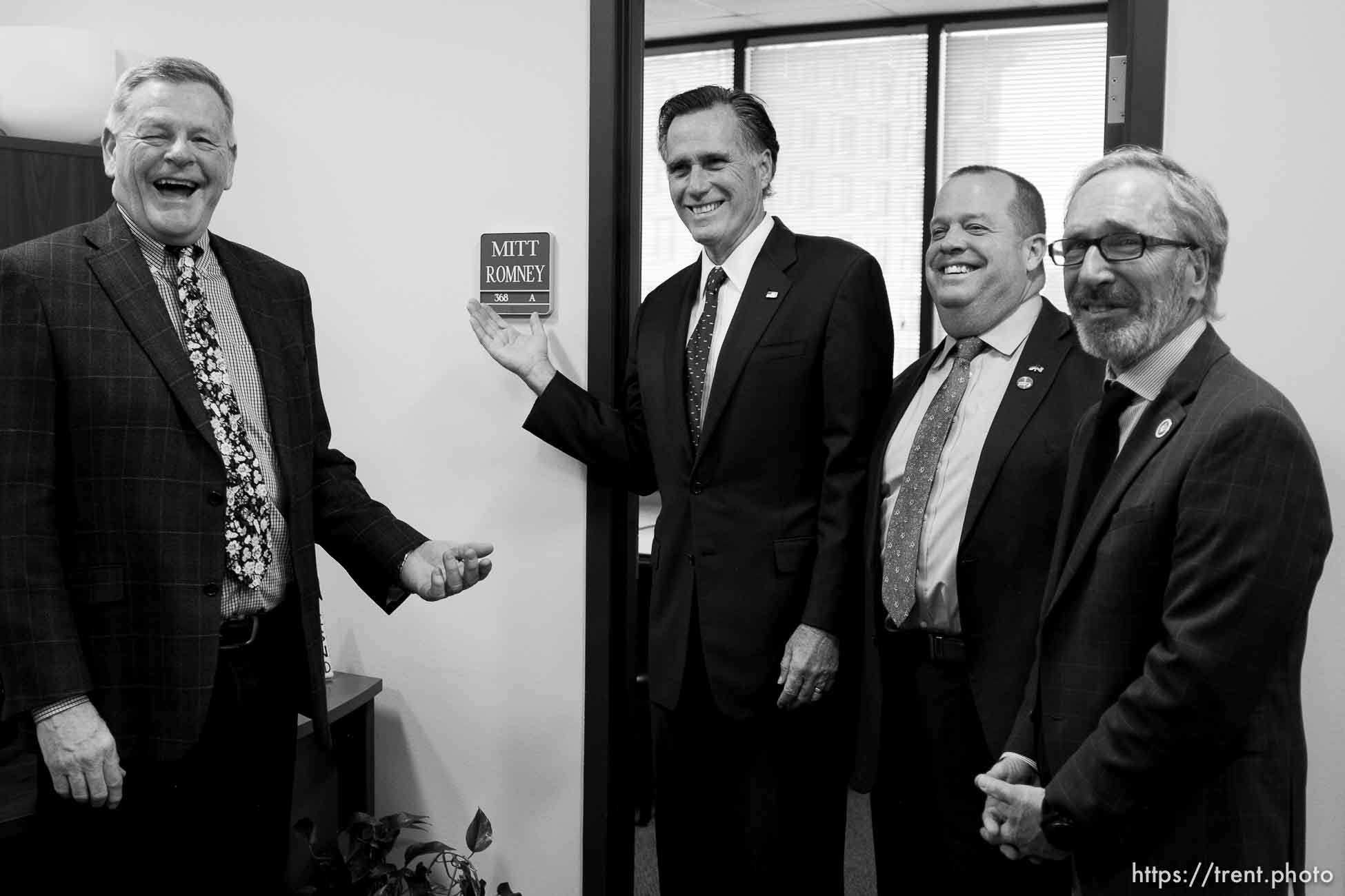 (Trent Nelson | The Salt Lake Tribune)
Senator Mitt Romney poses in front of a conference room bearing his name after meeting with Weber County Comissioners in Ogden to discuss the ongoing government shutdown on Friday Jan. 18, 2019. From left, Commissioner Scott Jenkins, Romney, Commissioner James Harvey, and Commissioner Gage Froerer.