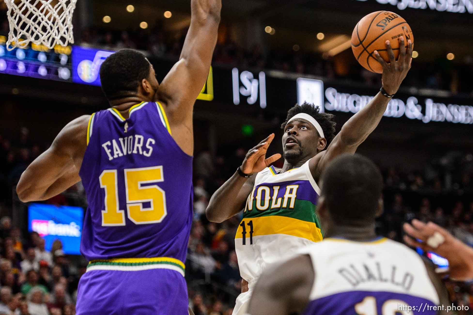 (Trent Nelson | The Salt Lake Tribune)  
New Orleans Pelicans guard Jrue Holiday (11) shoots with Utah Jazz forward Derrick Favors (15) defending as the Utah Jazz host the New Orleans Pelicans, NBA basketball in Salt Lake City on Monday March 4, 2019.