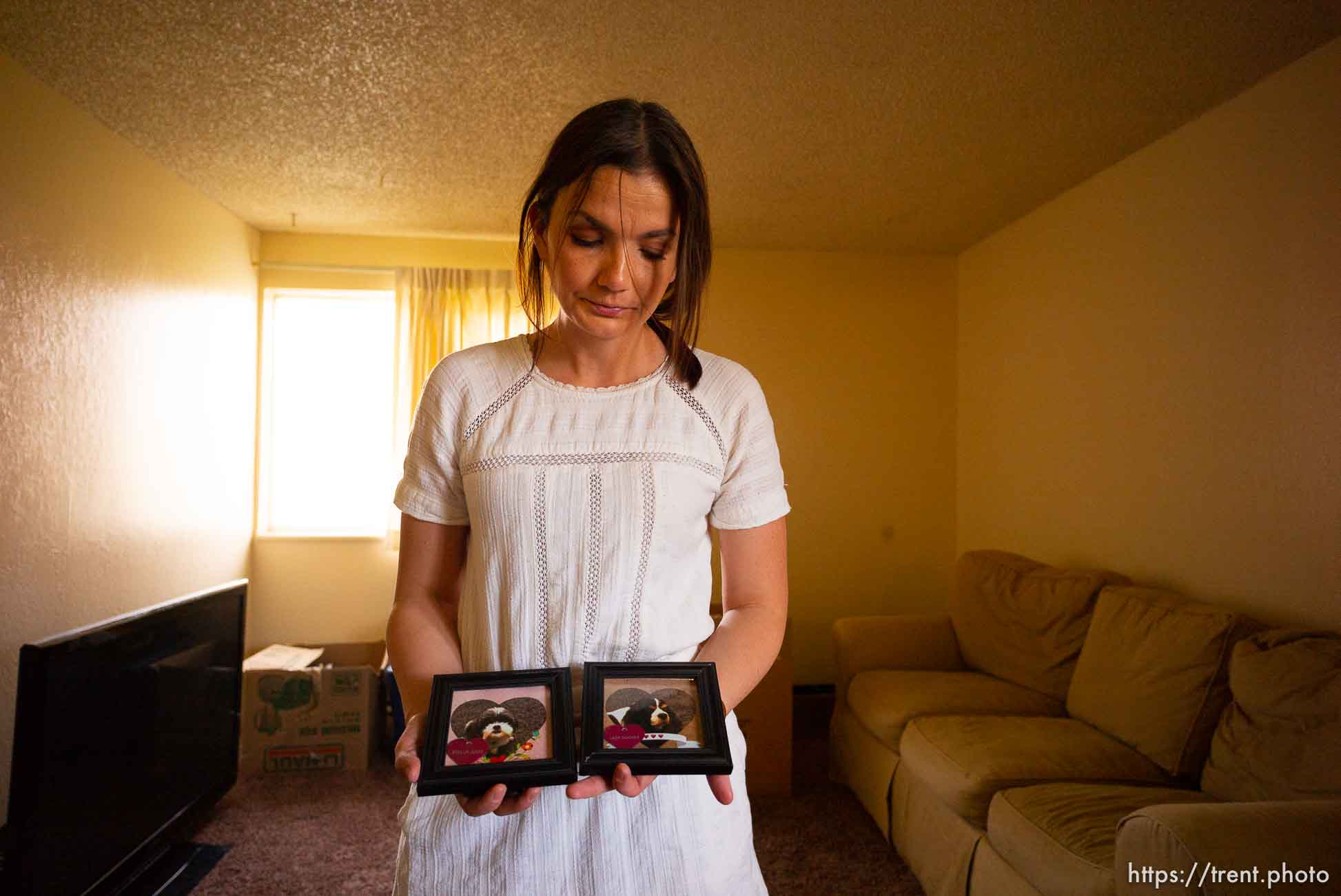 (Trent Nelson  |  The Salt Lake Tribune)  
Michelle Densley gets emotional showing photos of two dogs she had to give up when her living conditions changed, at her apartment in Salt Lake County on Monday April 8, 2019.