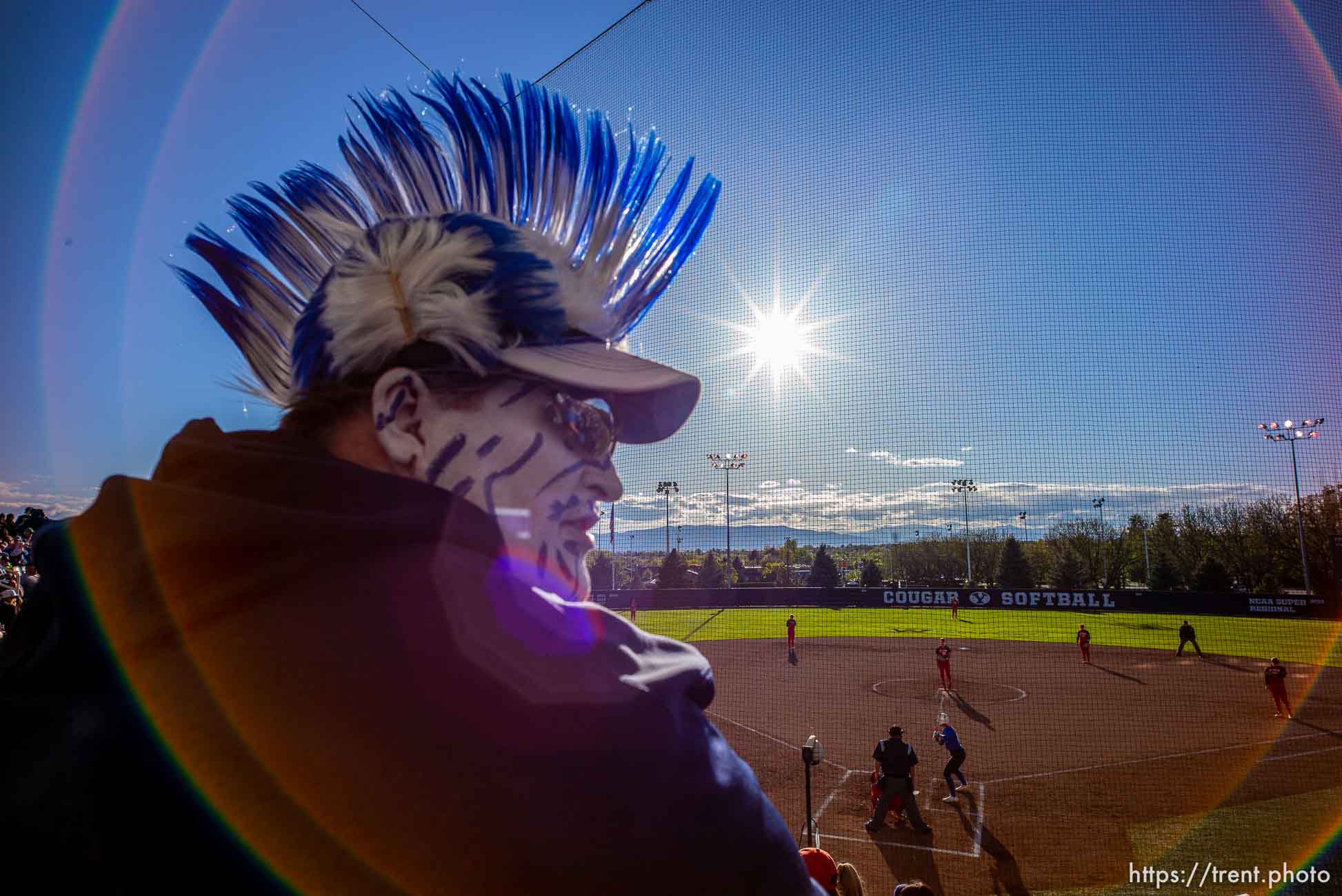 (Trent Nelson  |  The Salt Lake Tribune)  
The evening sun flares the lens as BYU fan Troy Beagley watches BYU host the University of Utah, NCAA softball in Provo on Wednesday May 1, 2019.