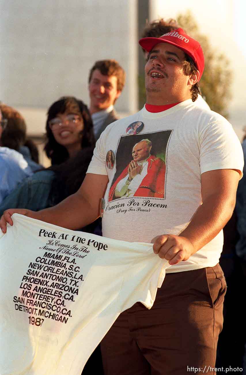 Guy selling Pope t-shirts at the Pope's visit.