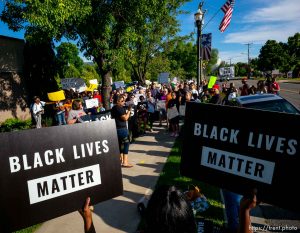 (Trent Nelson  |  The Salt Lake Tribune)
Lex Scott leads chants at a protest organized by Black Lives Matter and other groups at the Woods Cross Police Department on Friday June 14, 2019. The rally was to show support for DJ Hrubes, a 10-year-old black child who was held at gunpoint by a police officer last week while playing in his grandmother's front yard.