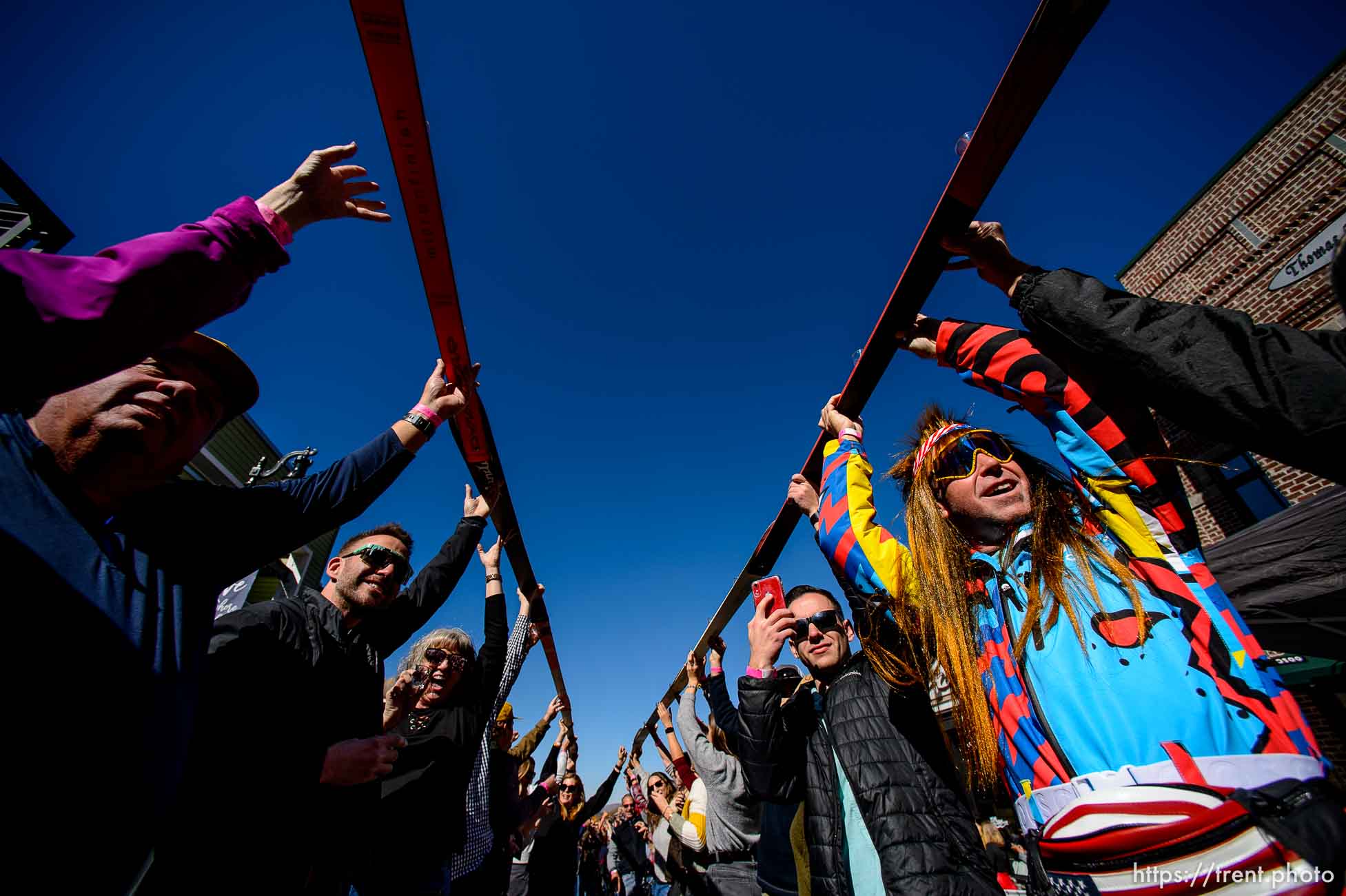 (Trent Nelson  |  The Salt Lake Tribune)  
Participants lift up their skis on Park City’s Historic Main Street after drinking a shot at the annual Shot Ski event on Saturday Oct. 12, 2019.