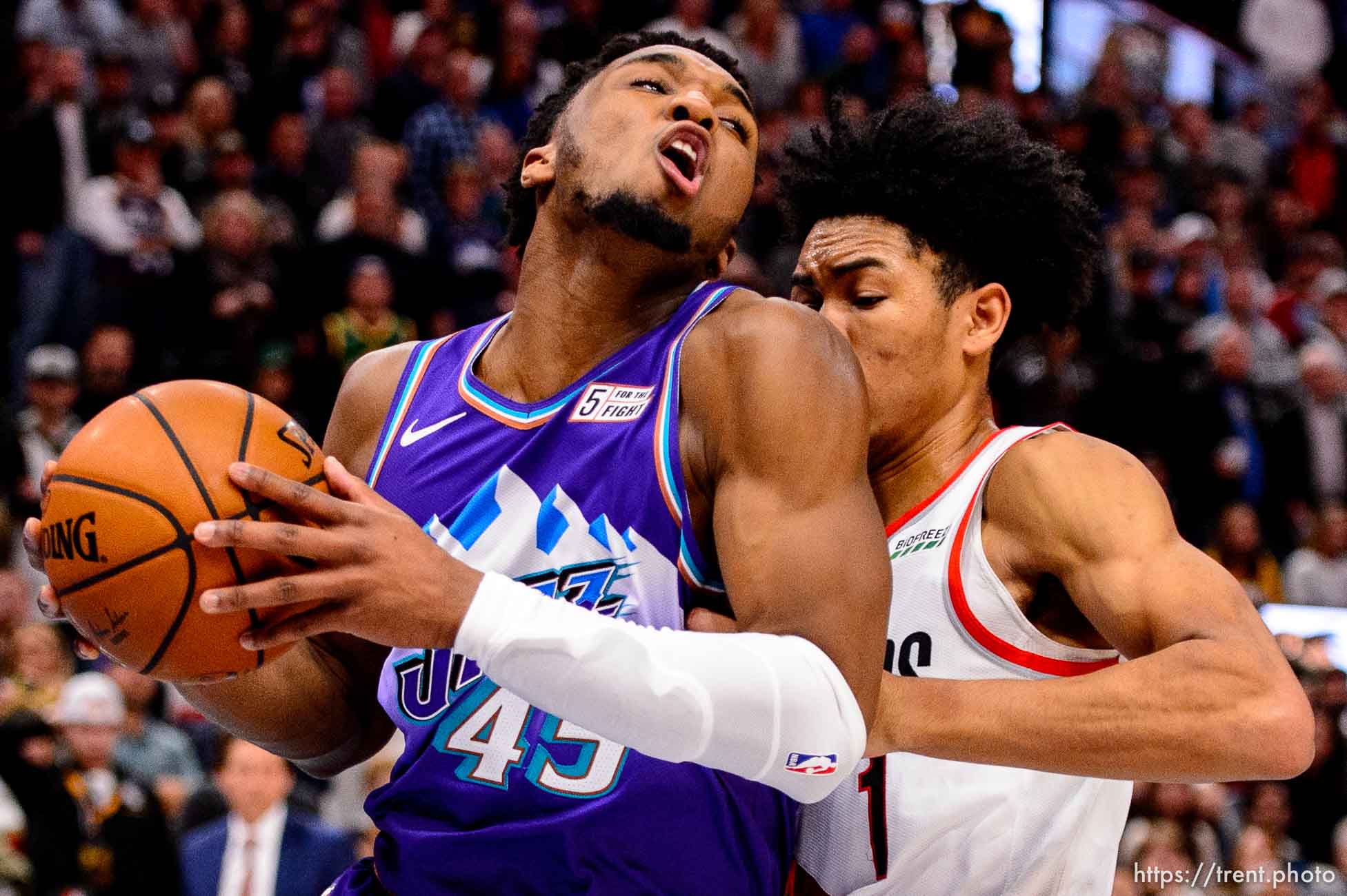 (Trent Nelson  |  The Salt Lake Tribune) Utah Jazz guard Donovan Mitchell (45) is fouled by Portland Trail Blazers guard Anfernee Simons (1) in the fourth quarter as the Utah Jazz host the Portland Trail Blazers, NBA basketball in Salt Lake City on Thursday, Dec. 26, 2019.