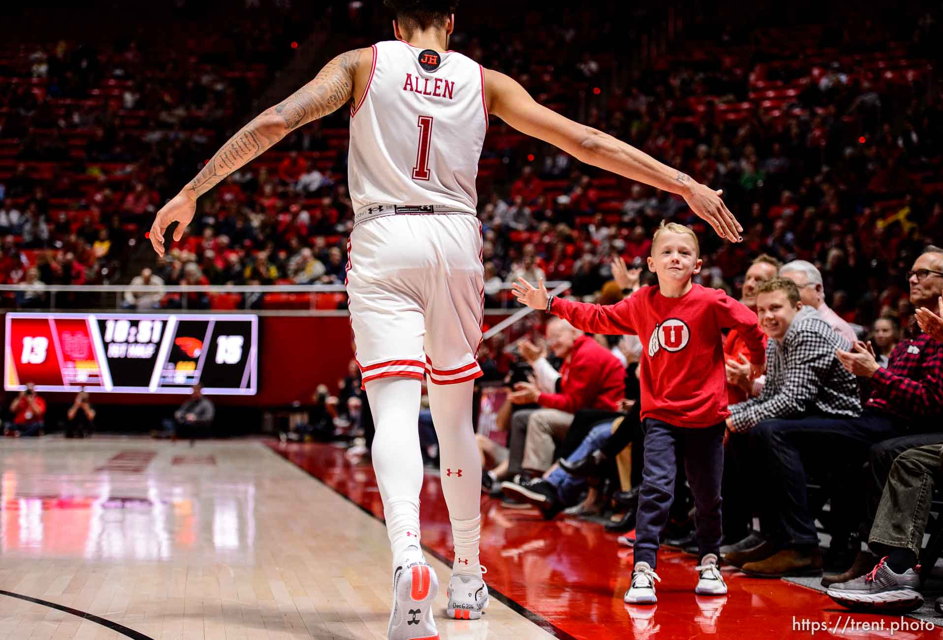 (Trent Nelson  |  The Salt Lake Tribune) Utah fan Jensen Brain gets a high-five from Utah Utes forward Timmy Allen (1) as the University of Utah hosts Oregon State, NCAA men's basketball in Salt Lake City on Thursday, Jan. 2, 2020.