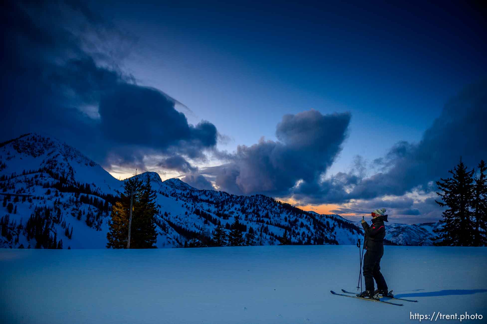 (Trent Nelson  |  The Salt Lake Tribune) A skier photographs the fading sunset during a night skiing session at Brighton on Monday, Feb. 24, 2020.