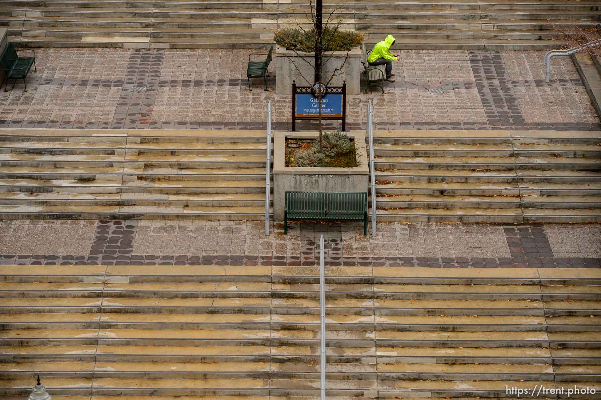 (Trent Nelson  |  The Salt Lake Tribune) A man looks at his phone in an empty Gallivan Center in Salt Lake City on Monday, March 23, 2020.